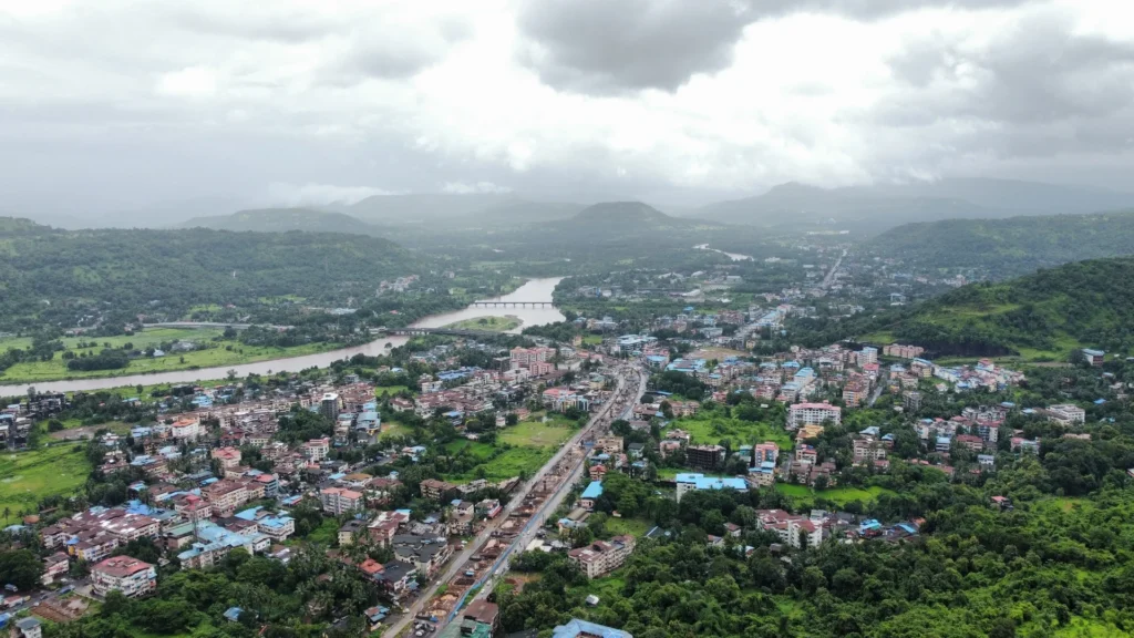 Monsoon sky view of Chiplun city with lush greenery and cloud-covered hills