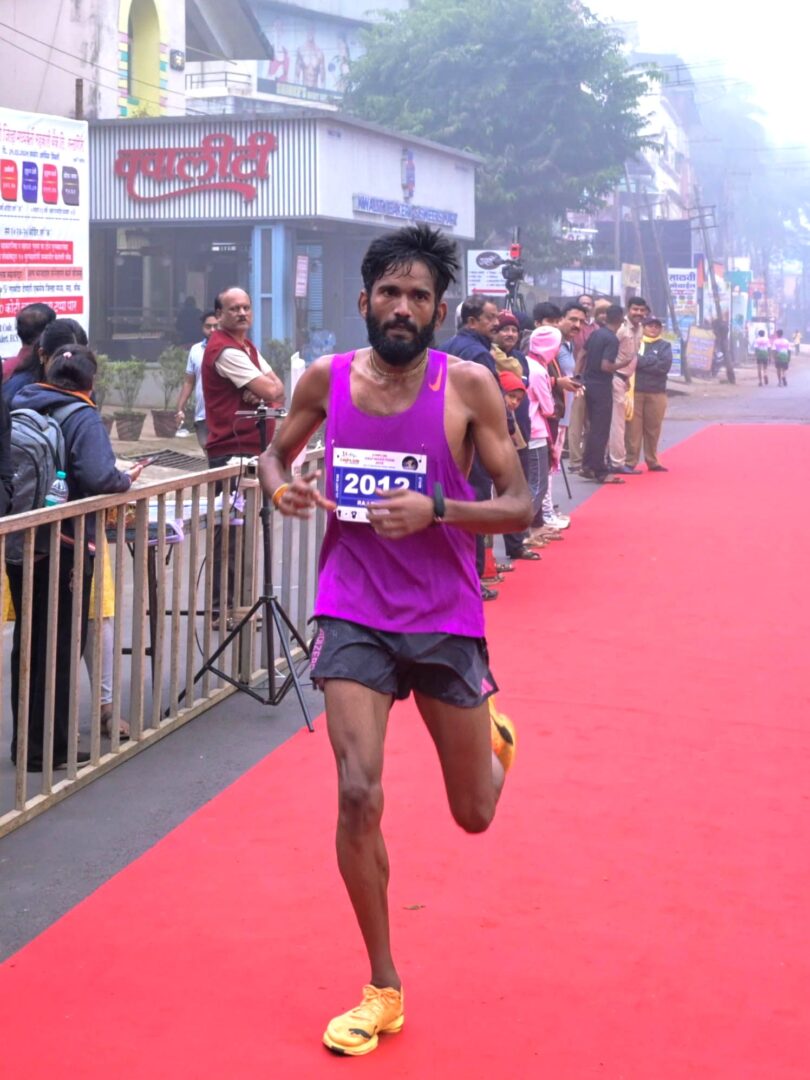 Raj Tiwari, first-rank winner of the 21K Chiplun Half Marathon, celebrates his victory.